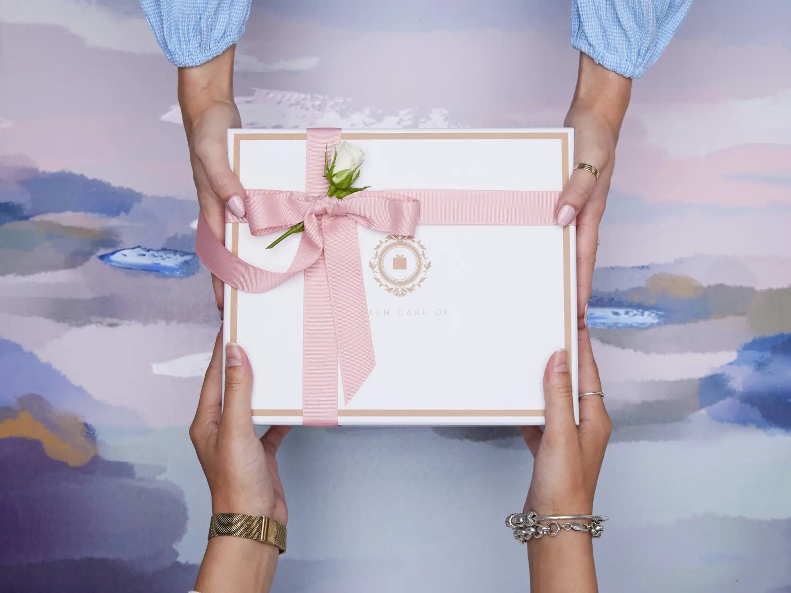 Two people exchanging a beautifully wrapped gift box — the art of thoughtful and intentional gift giving